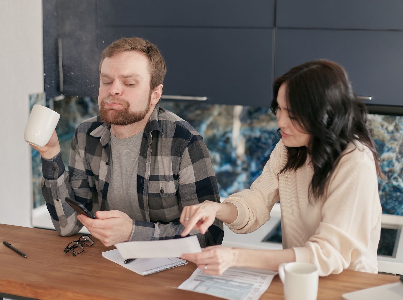 Veteran and spouse reviewing Camp Lejeune VA benefits paperwork together at their kitchen table