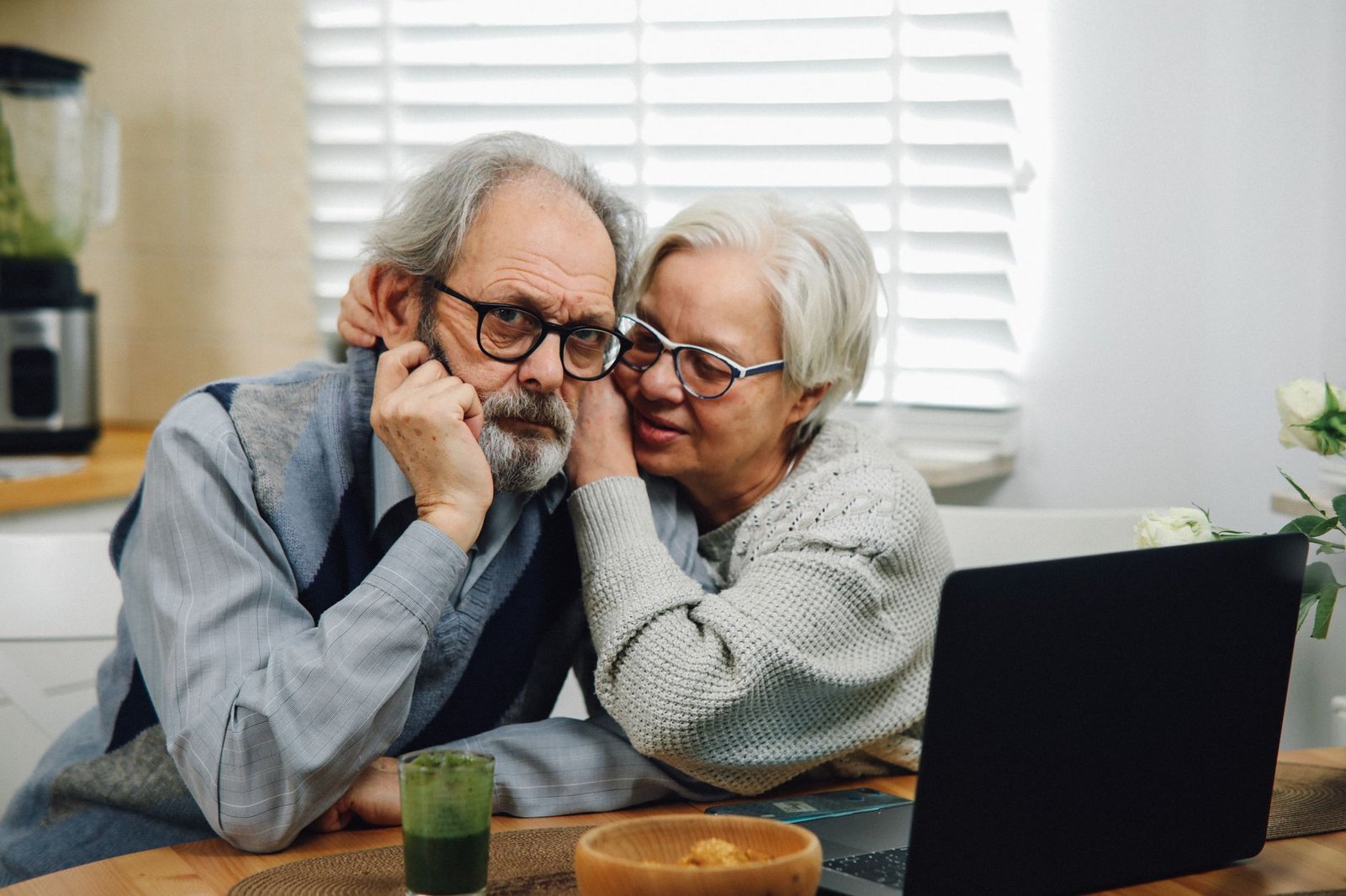 Veteran and spouse checking official VA.gov information together to guard against benefit scams