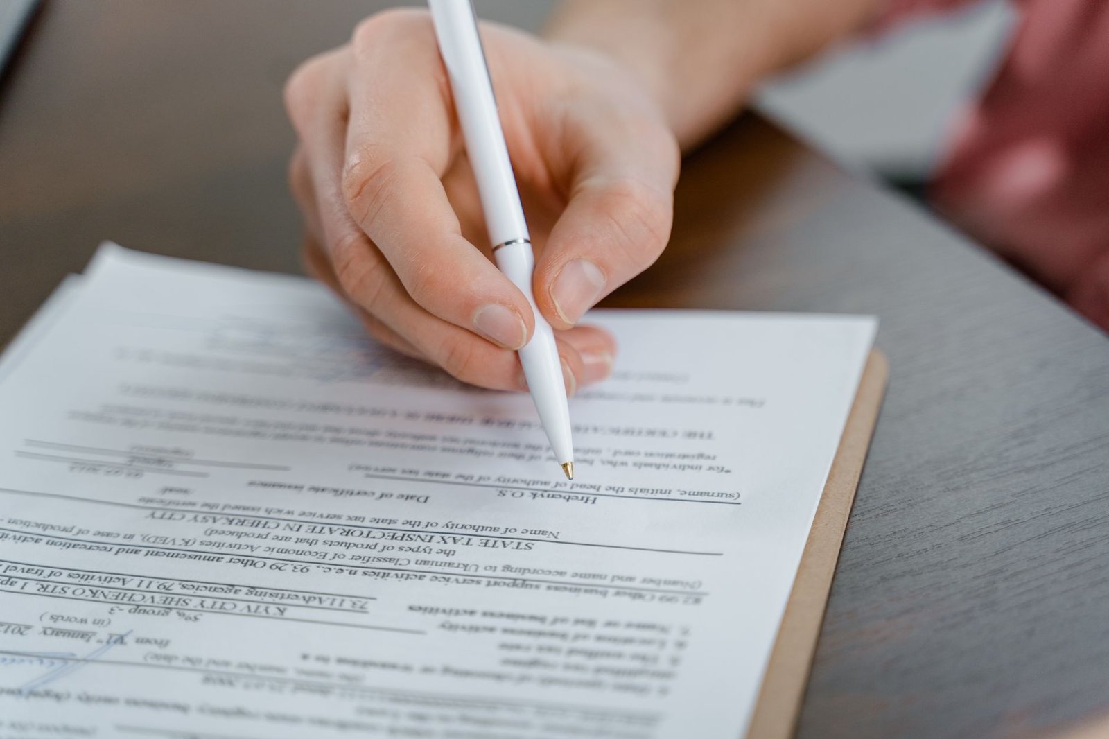 Veteran completing burn pit exposure VA benefits claim forms at a desk at home