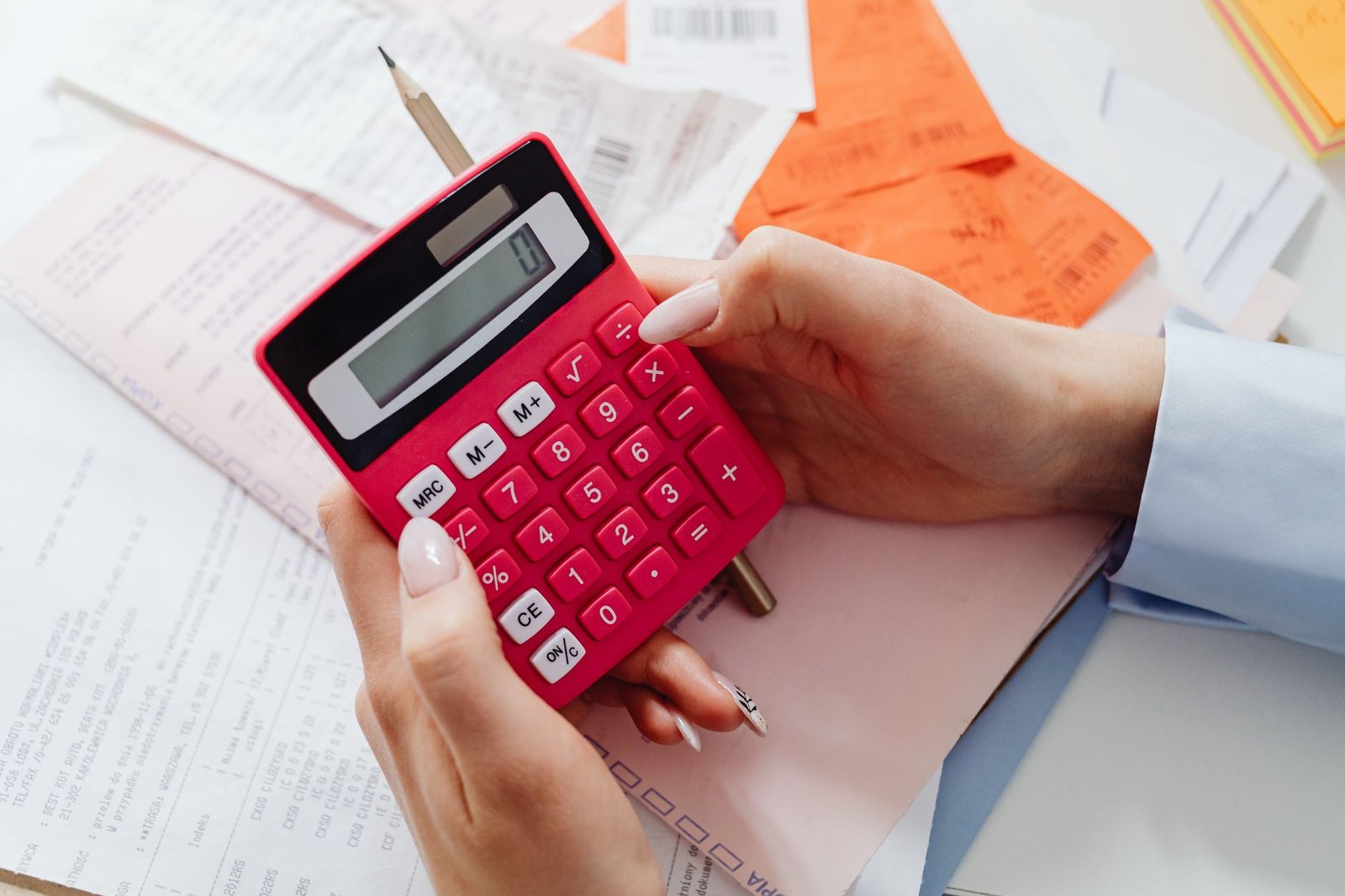 Hands using a calculator to figure savings from property tax relief for a disabled veteran