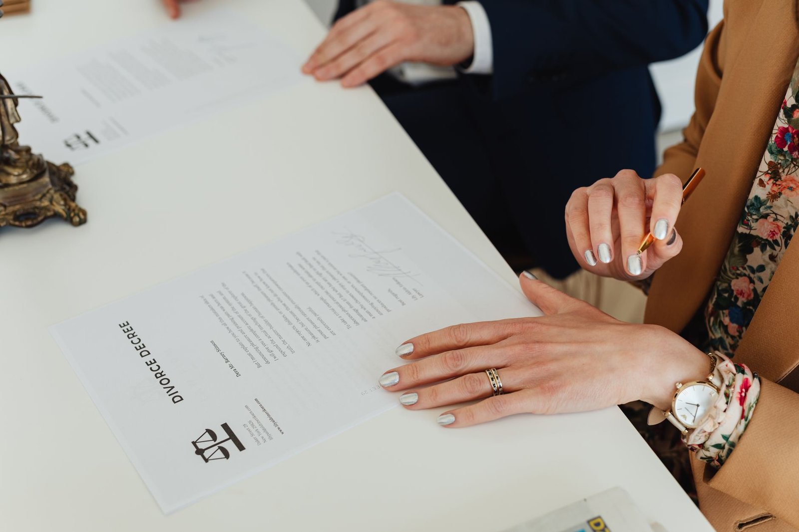 Hands reviewing paperwork related to VA disability and divorce decisions