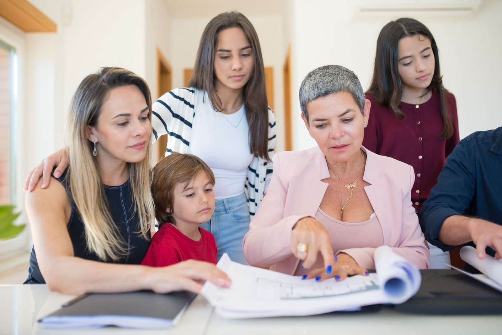 Surviving spouse and child reviewing Fry Scholarship application paperwork together at home